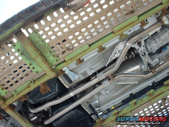 Undercarriage view of a vehicle's exhaust system and transmission