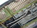 2007 Ford Mustang - The underside of a vehicle reveals its exhaust pipes and transmission components, with some visible text on a part.