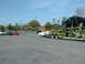 2007 Ford Mustang - A car carrier is being loaded with vehicles on a sunny day.