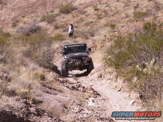 Black 2004 Jeep TJ driving off-road