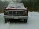 1901 Honda Odyssey - A red Ford F-Series truck sits parked in the snow during winter weather.