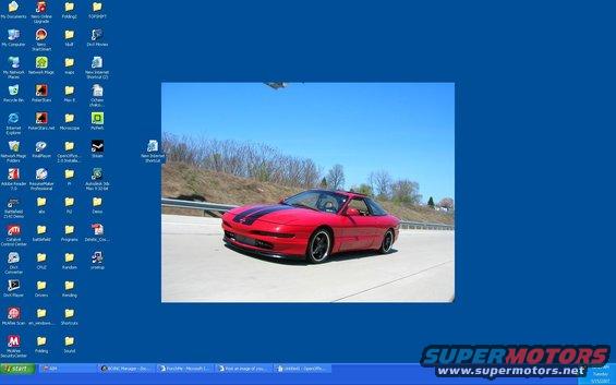 Red sports coupe with black stripes on a highway