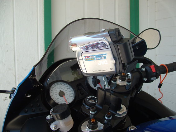 Motorcycle dashboard with JVC video camera mounted on handlebars