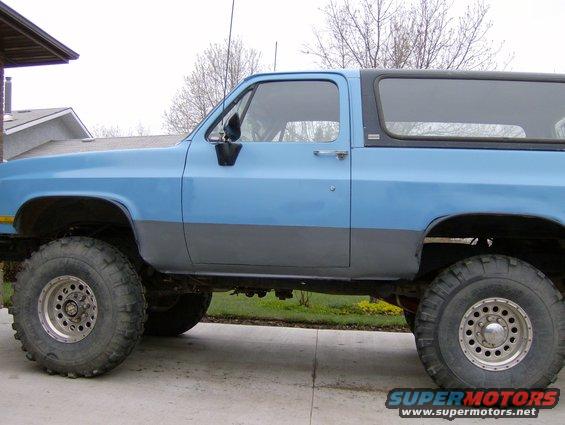 Side view of a blue and grey 1989 Chevrolet Blazer with large tires