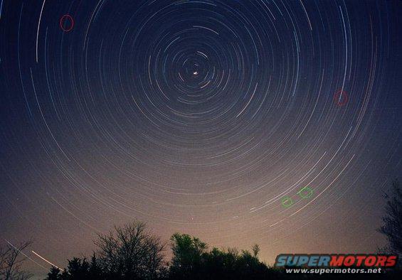 Star trails over trees with Supermotors.net logo