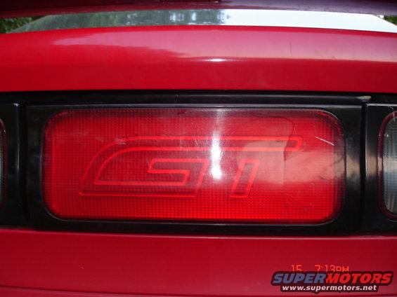 Red taillight with a black bezel and a red GT emblem inside. The car body is red