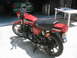 1981 Kawasaki Bayou - A red 1981 Kawasaki GPz 550 motorcycle is parked in a garage, with a green car visible behind it.