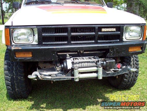 1984 Toyota 4Runner front bumper with winch, black grille, and Toyota badge