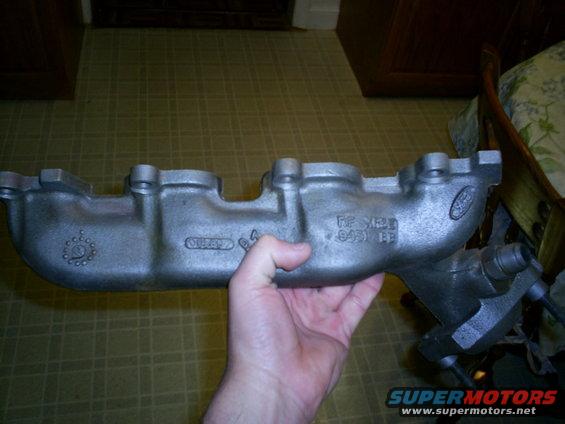Exhaust manifold with Ford logo and part numbers