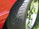 1967 Ford Mustang - Detail shot of a tire and wheel assembly on a red vehicle.