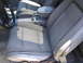 1967 Ford Mustang - Interior view of a car's front seats and dashboard area, showing gray upholstery and a center console.