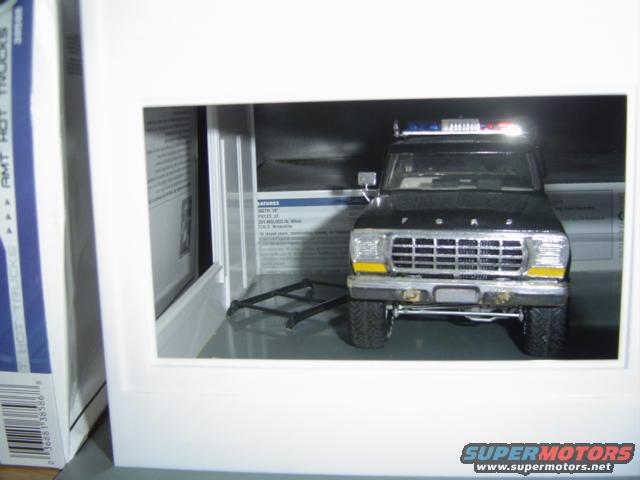 Black 1979 Ford Bronco model with yellow turn signals and a light bar on the roof