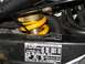 2002 Honda Interceptor - Close-up view of a motorcycle's rear suspension component and a tire information label.