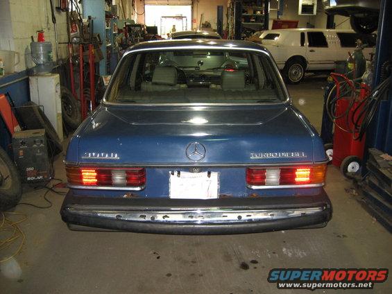 Blue Mercedes-Benz sedan rear view, showing "300D TURBO DIESEL" badge and chrome bumper