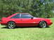 1967 Ford Mustang - This red coupe, identified as a 1993 Ford Mustang, is viewed from its side profile.