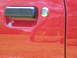 1967 Ford Mustang - The shiny red paint on the car door reflects the surroundings.