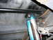 1988 Ford Bronco - The image shows a close-up view of the rear suspension, blue off-road shocks and a sway bar.