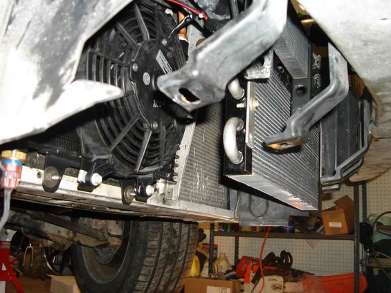 Transmission cooler and fan assembly mounted below a vehicle's undercarriage
