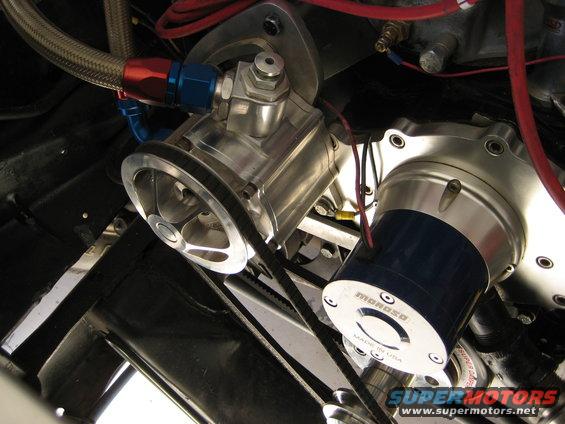 Close-up of engine parts including a pulley and a Moroso component with a belt connecting them