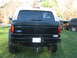 1995 Ford Bronco - This 1995 Ford Bronco is seen from the rear, a tan removable top and a humorous sticker on the back window.