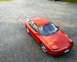 1993 Ford Probe - This red 1993 Ford Probe is seen from a high angle, parked on a gravel surface.