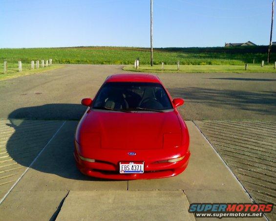 Red 1993 Ford Probe parked on concrete, front view. License plate EBS 4371