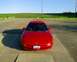1993 Ford Probe - A red 1993 Ford Probe is parked outdoors on a sunny day, facing the camera.