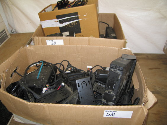 Cardboard boxes filled with electronic equipment, cables, and mounting brackets. Labels read 'SEABANK 531'