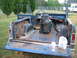 1992 Ford Mustang - This 1974 Ford Bronco is in a state of disrepair, with significant rust visible in the bed and interior. A shop vac and fast food bag sit i…