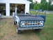 1992 Ford Mustang - This early Ford Bronco is undergoing restoration, parked outside a suburban garage.