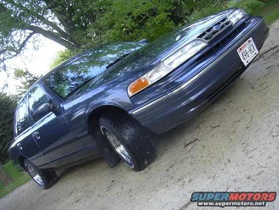 Dark blue sedan with chrome trim and a license plate reading 498-HCV