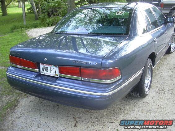 1996 Ford Crown Victoria rear quarter view, blue paint, chrome trim, Wisconsin license plate 498-HCV