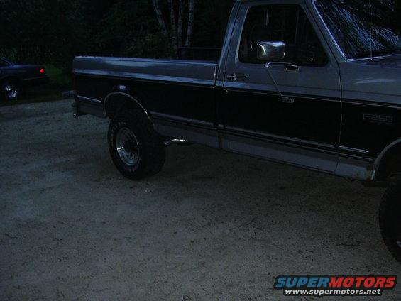 Side view of a two-tone pickup truck, possibly a 1990 Ford F-250