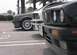 1989 BMW 3 Series - Three BMW 3 Series cars are parked in a lot, with a close-up on the front of the black car.