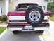 1994 Ford Bronco - This Ford Bronco features a two-tone paint scheme and a rear-mounted spare tire.