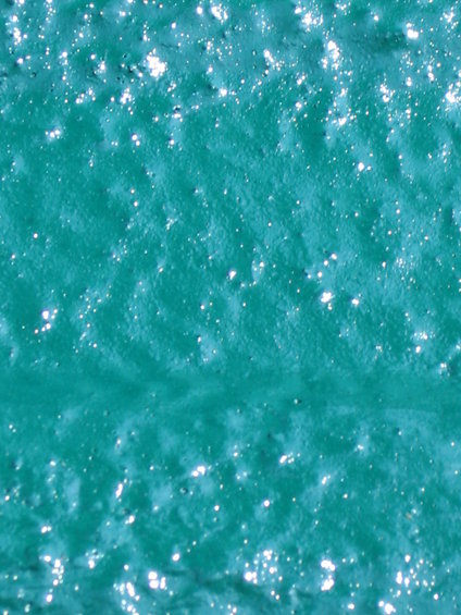 Textured teal surface with small white glitter flecks