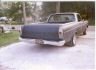 1966 Ford Ranchero pickup truck, rear view, silver and dark gray, on a paved driveway