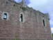 1995 Ford Bronco - Exterior view of a historic stone castle, arched windows and defensive turrets under a cloudy sky.