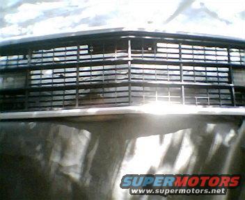 Front grille assembly with horizontal bars and headlight cutouts