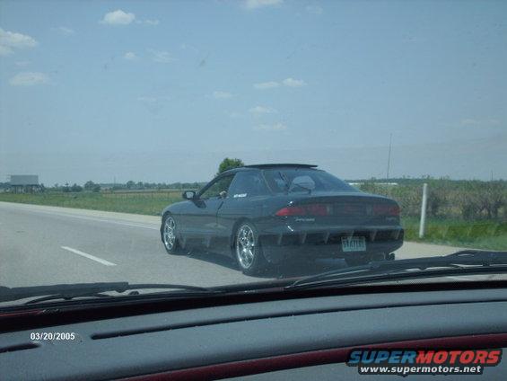 black coupe driving on highway, seen from inside another car