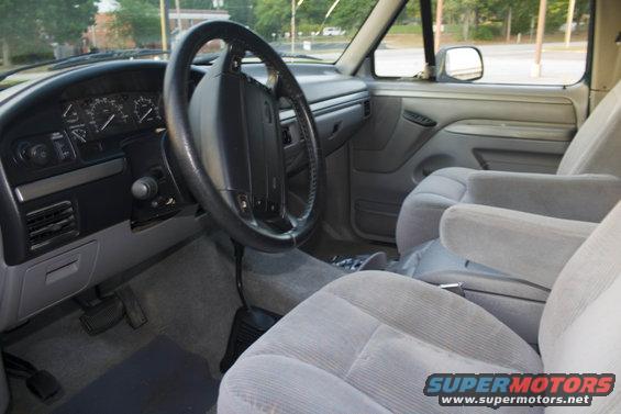 Gray interior with dashboard, steering wheel, and bucket seats. 1995 Ford Bronco