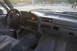 1995 Ford Bronco - The interior of a vehicle is shown, the dashboard, steering wheel, and seats.