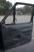 1995 Ford Bronco - Interior view of a 1995 Ford Bronco's driver side door panel and window.
