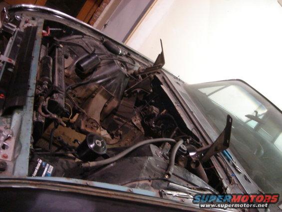 1962 Ford Thunderbird engine bay during restoration, showing wiring and engine components