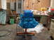 1962 Ford Thunderbird - A blue engine is mounted on an orange stand in a cluttered workshop environment.