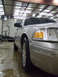 2004 Ford Crown Victoria - A silver 2004 Ford Crown Victoria is parked indoors on a wet floor.