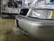 2004 Ford Crown Victoria - A silver 2004 Ford Crown Victoria is parked in front of a fire truck.
