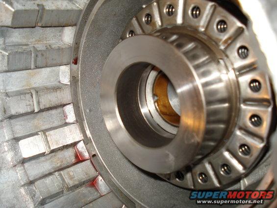 Close-up of a transmission part with a bearing and metal fins. Red marks visible on fins