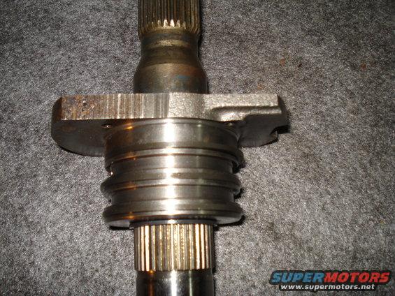 Close-up of a splined shaft with a flange and bearing assembly