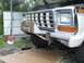 1979 Ford Bronco - The front of a truck is shown with a custom winch bumper installed over the original grille.